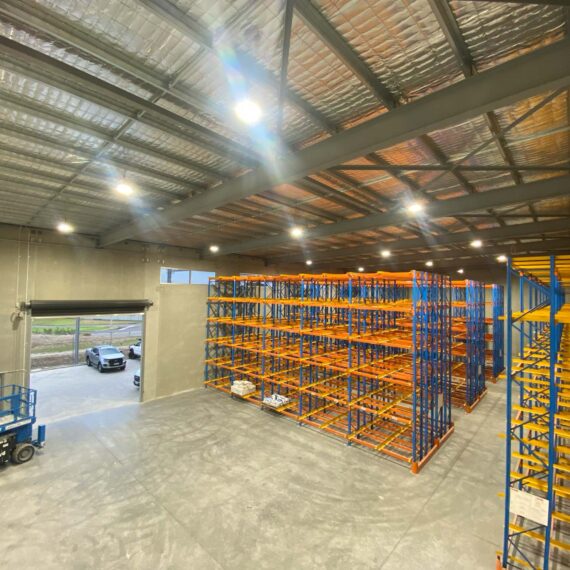 A warehouse interior with high racks of shelving.