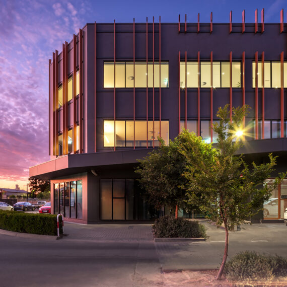 A modern building seen from outside at sunset.